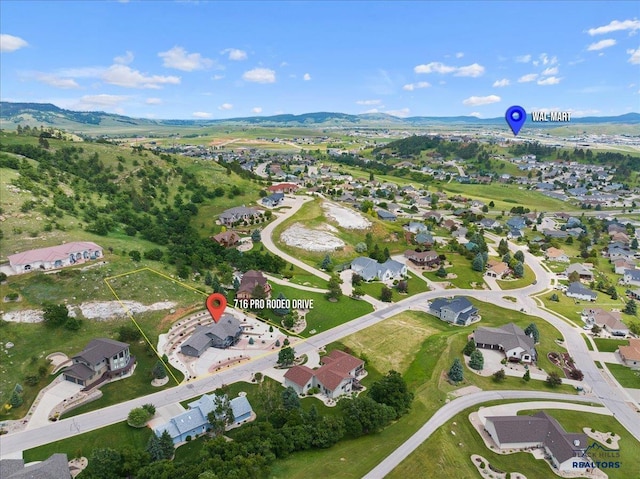 drone / aerial view featuring a residential view and a mountain view