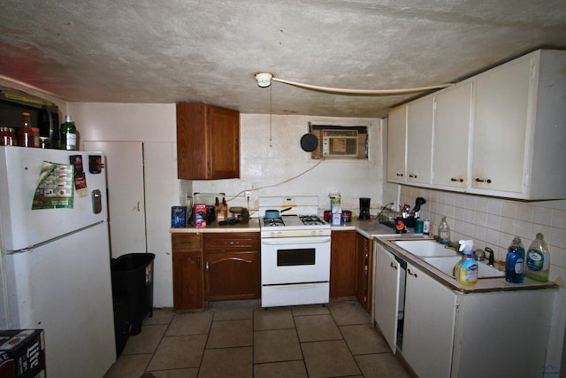 920 Haines Ave, Rapid City, SD 57701 - kitchen featuring light countertops, light tile patterned floors, decorative backsplash, white appliances, and a wall mounted AC
