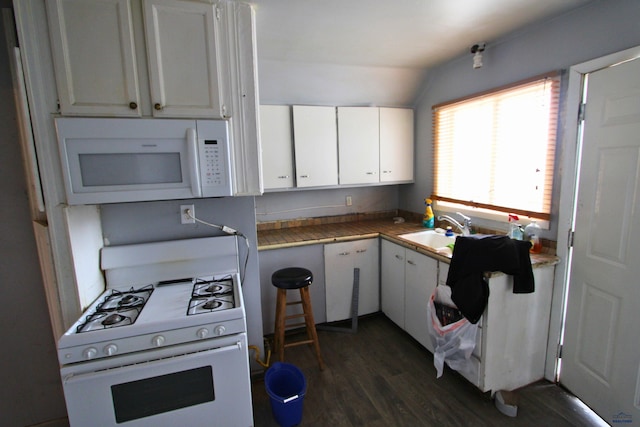 920 Haines Ave, Rapid City, SD 57701 - kitchen with dark wood finished floors, white appliances, white cabinetry, and vaulted ceiling