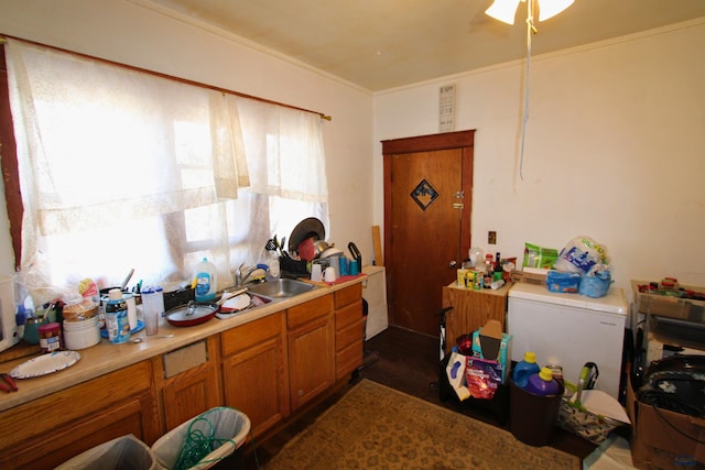920 Haines Ave, Rapid City, SD 57701 - kitchen with brown cabinets, light countertops, ceiling fan, and a sink
