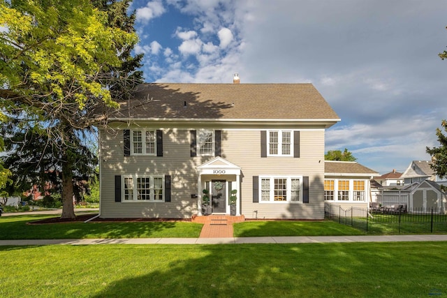 1000 W Blvd, Rapid City, SD 57701 - colonial inspired home with a chimney, a front yard, and fence