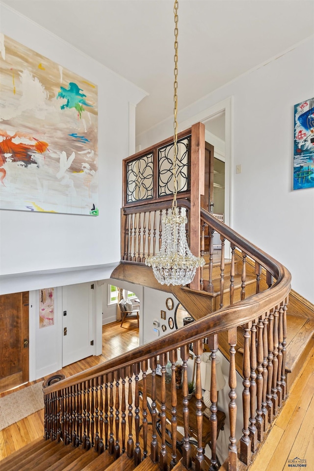 1000 W Blvd, Rapid City, SD 57701 - stairs featuring an inviting chandelier and hardwood / wood-style flooring
