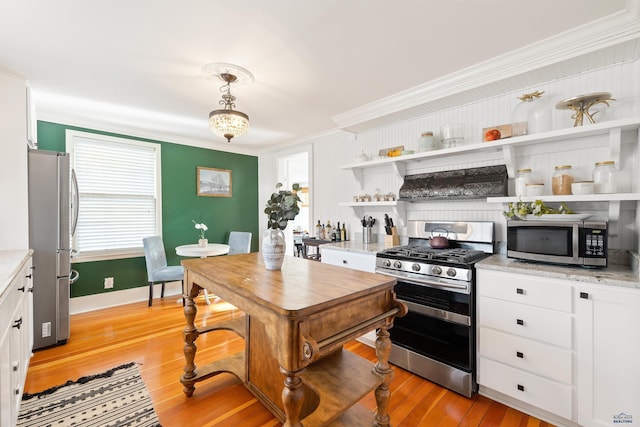 1000 W Blvd, Rapid City, SD 57701 - kitchen with crown molding, light wood-type flooring, appliances with stainless steel finishes, white cabinetry, and open shelves
