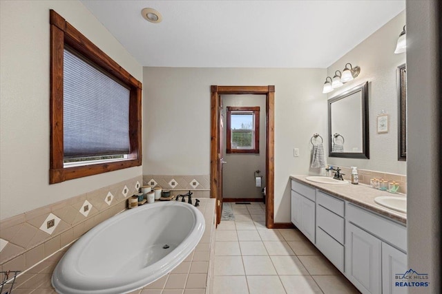 19329 US Highway 85, Belle Fourche, SD 57717 - full bathroom with double vanity, tile patterned flooring, a sink, and a garden tub