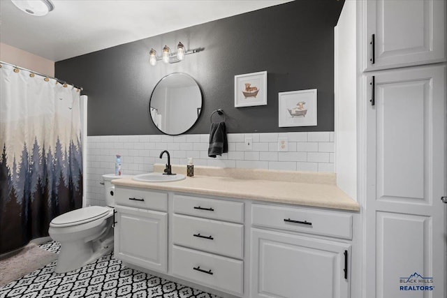 19329 US Highway 85, Belle Fourche, SD 57717 - bathroom with tile walls, a wainscoted wall, toilet, vanity, and tile patterned flooring