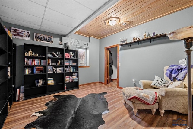 19329 US Highway 85, Belle Fourche, SD 57717 - living area featuring baseboards, wood finished floors, a paneled ceiling, and wooden ceiling