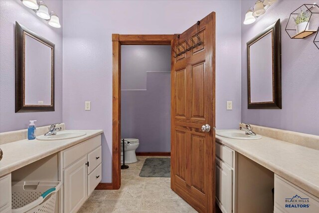 19329 US Highway 85, Belle Fourche, SD 57717 - bathroom featuring baseboards, toilet, and vanity