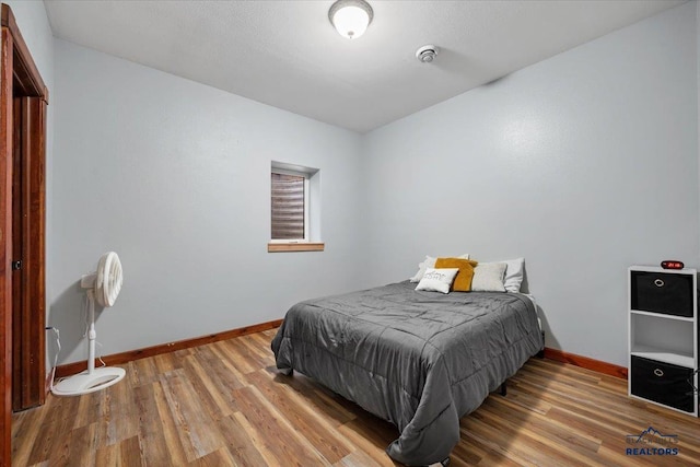 19329 US Highway 85, Belle Fourche, SD 57717 - bedroom featuring baseboards and wood finished floors