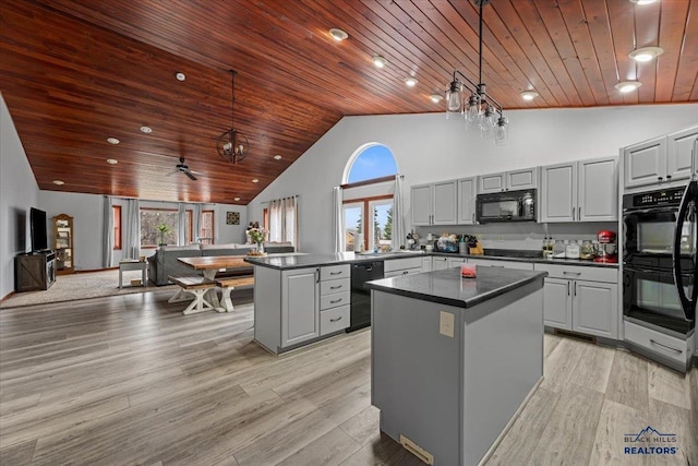 19329 US Highway 85, Belle Fourche, SD 57717 - kitchen with gray cabinetry, black appliances, dark countertops, and a peninsula