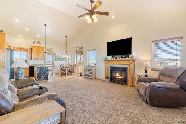 living room with light carpet, high vaulted ceiling, a healthy amount of sunlight, and ceiling fan