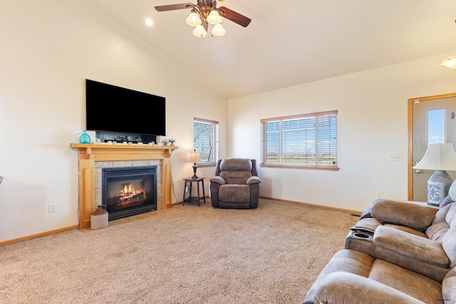 carpeted living room featuring baseboards, a fireplace, high vaulted ceiling, and a ceiling fan