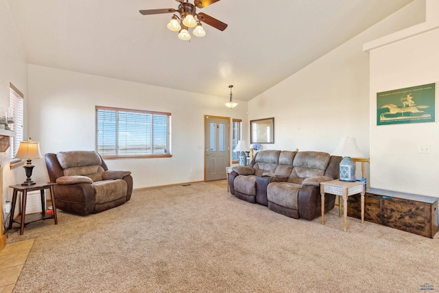 living room featuring a ceiling fan, light carpet, high vaulted ceiling, and baseboards