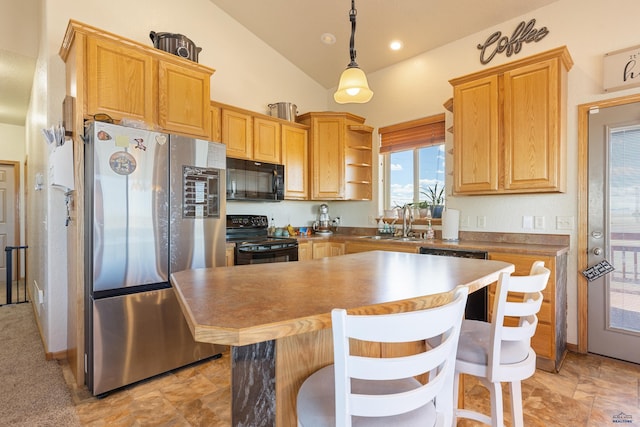 kitchen featuring a sink, hanging light fixtures, black appliances, vaulted ceiling, and a center island