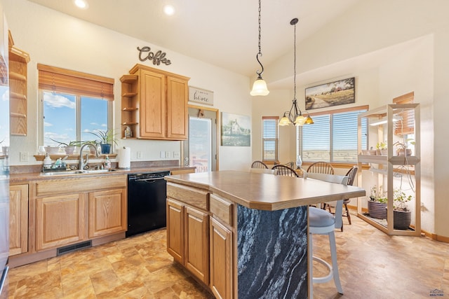 kitchen with visible vents, a breakfast bar, black dishwasher, a sink, and a center island