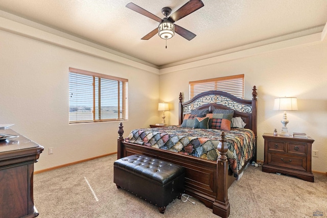 carpeted bedroom with baseboards, a textured ceiling, and ceiling fan