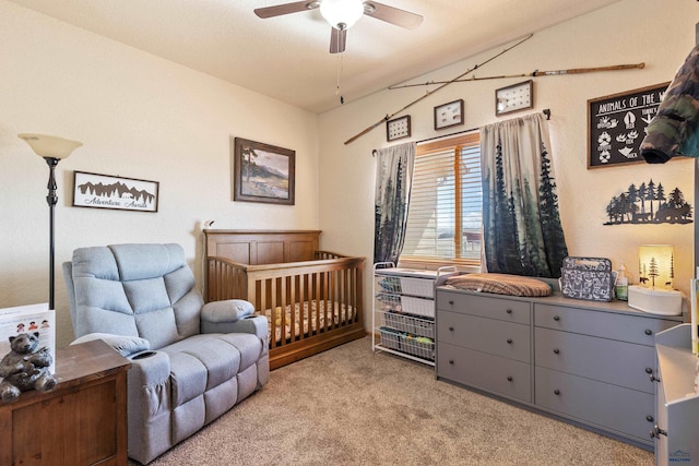 bedroom featuring light carpet, lofted ceiling, and ceiling fan