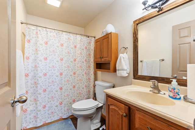 bathroom featuring a shower with curtain, toilet, and vanity
