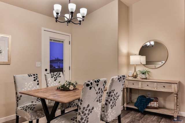 dining area with baseboards, a chandelier, and dark wood-style floors