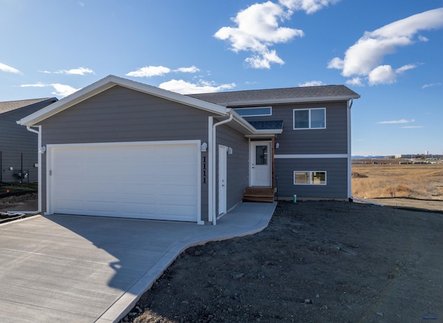 view of front facade featuring driveway, an attached garage, and entry steps