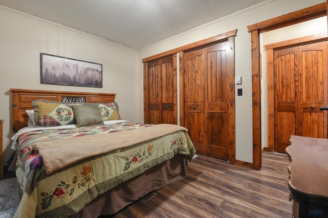 bedroom with a closet, baseboards, and wood finished floors