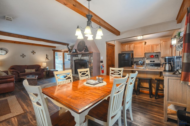 dining space featuring beam ceiling, a fireplace, dark wood-style floors, and a chandelier