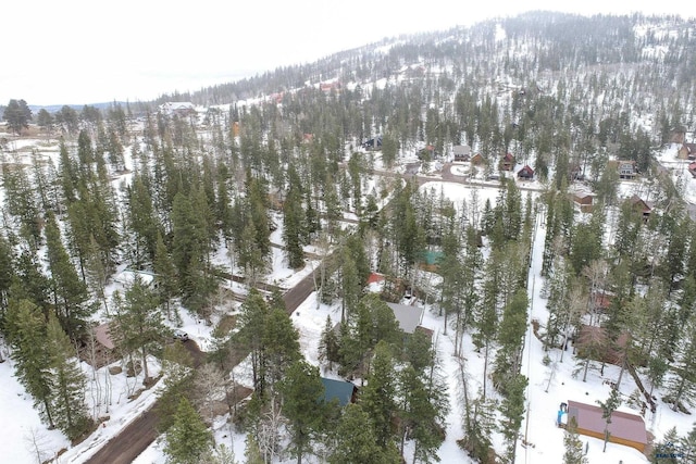 snowy aerial view featuring a view of trees
