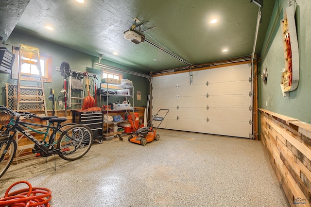 garage with recessed lighting and a garage door opener