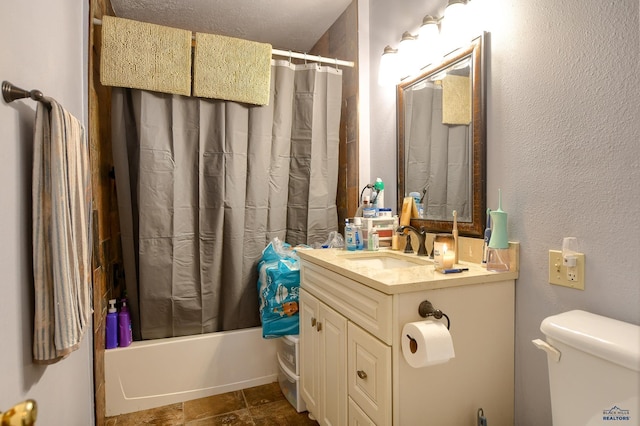 bathroom featuring vanity, shower / bathtub combination with curtain, toilet, a textured wall, and stone finish flooring