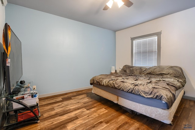 bedroom with baseboards, ceiling fan, and wood finished floors