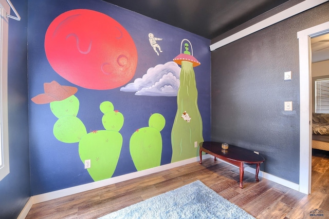 bedroom with baseboards and wood finished floors