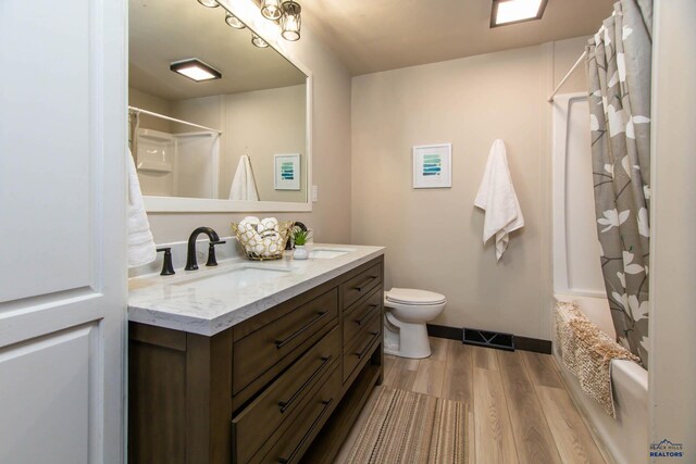 1920 Reservoir Rd, Rapid City, SD 57703 - bathroom with toilet, a sink, wood finished floors, visible vents, and double vanity