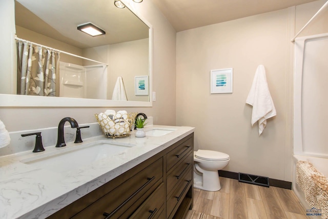 1920 Reservoir Rd, Rapid City, SD 57703 - bathroom with visible vents, a sink, curtained shower, and wood finished floors