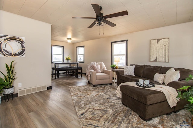 1920 Reservoir Rd, Rapid City, SD 57703 - living room featuring baseboards, visible vents, wood finished floors, and a ceiling fan