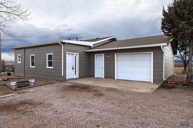 1920 Reservoir Rd, Rapid City, SD 57703 - single story home with dirt driveway, an attached garage, and roof with shingles
