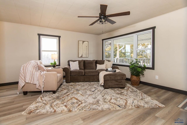 1920 Reservoir Rd, Rapid City, SD 57703 - living room with wood finished floors, baseboards, ceiling fan, and a wealth of natural light