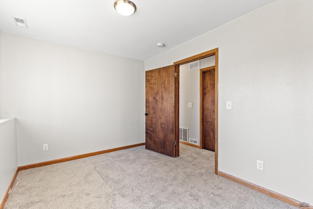 unfurnished room with baseboards, visible vents, and carpet floors