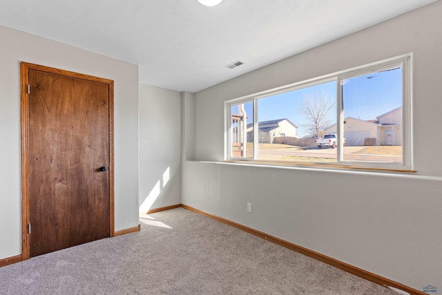 unfurnished bedroom featuring baseboards, carpet floors, visible vents, and a closet