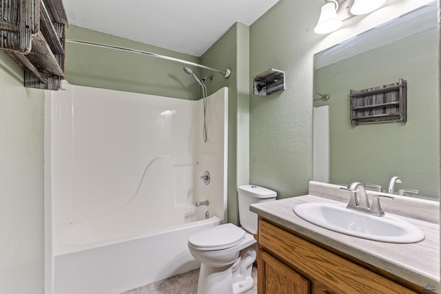 bathroom featuring tile patterned flooring, vanity, toilet, a textured wall, and washtub / shower combination