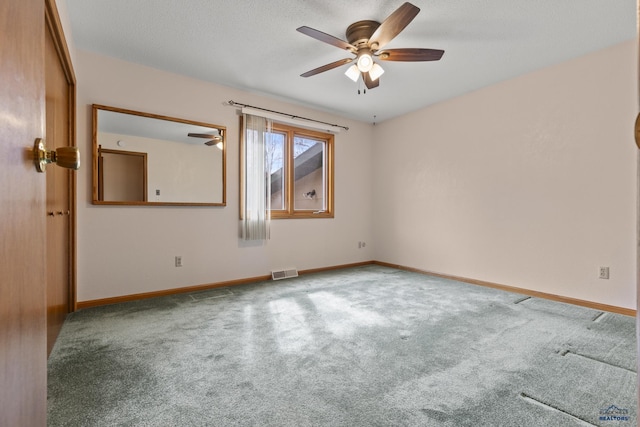 2506 Junction Dr, Rapid City, SD 57702 - carpeted empty room featuring baseboards, a textured ceiling, visible vents, and a ceiling fan