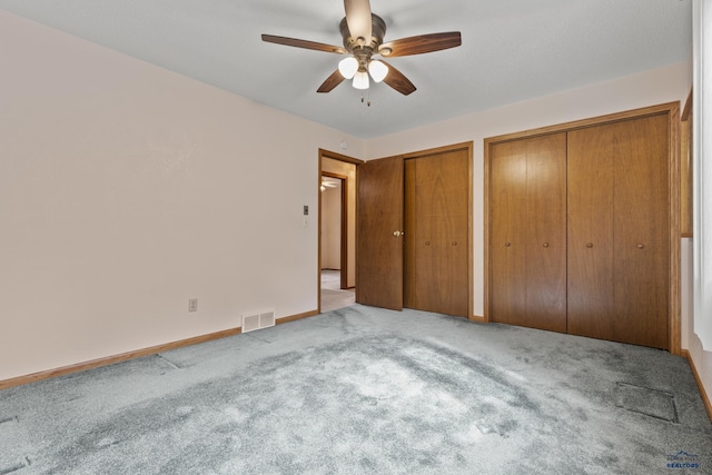 2506 Junction Dr, Rapid City, SD 57702 - unfurnished bedroom featuring two closets, carpet, baseboards, and visible vents