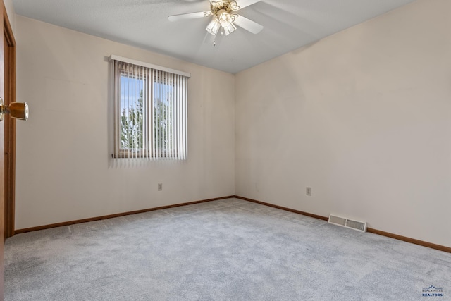 2506 Junction Dr, Rapid City, SD 57702 - carpeted empty room featuring baseboards, visible vents, and a ceiling fan