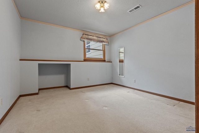 2506 Junction Dr, Rapid City, SD 57702 - unfurnished room with carpet flooring, a textured ceiling, visible vents, ornamental molding, and built in study area