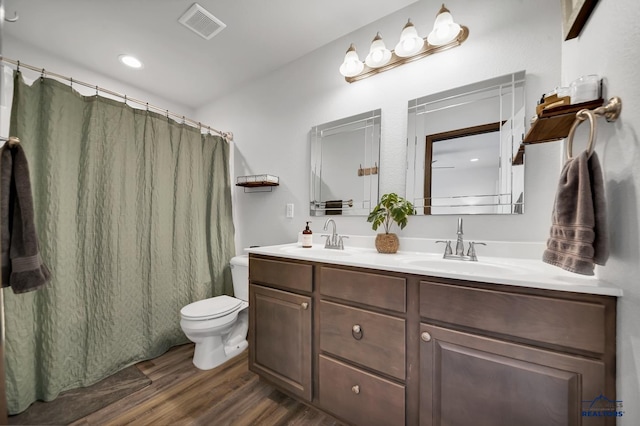 4400 Beringer Dr, Rapid City, SD 57703 - full bath with toilet, a sink, wood finished floors, and visible vents