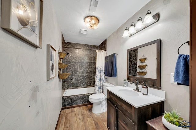 4400 Beringer Dr, Rapid City, SD 57703 - full bathroom with toilet, vanity, wood finished floors, shower / tub combo, and visible vents