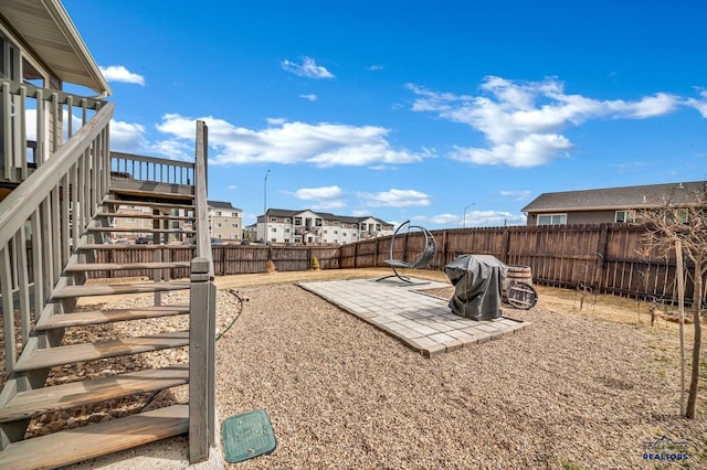 4400 Beringer Dr, Rapid City, SD 57703 - view of yard featuring stairs, a patio area, a wooden deck, a fenced backyard, and a residential view