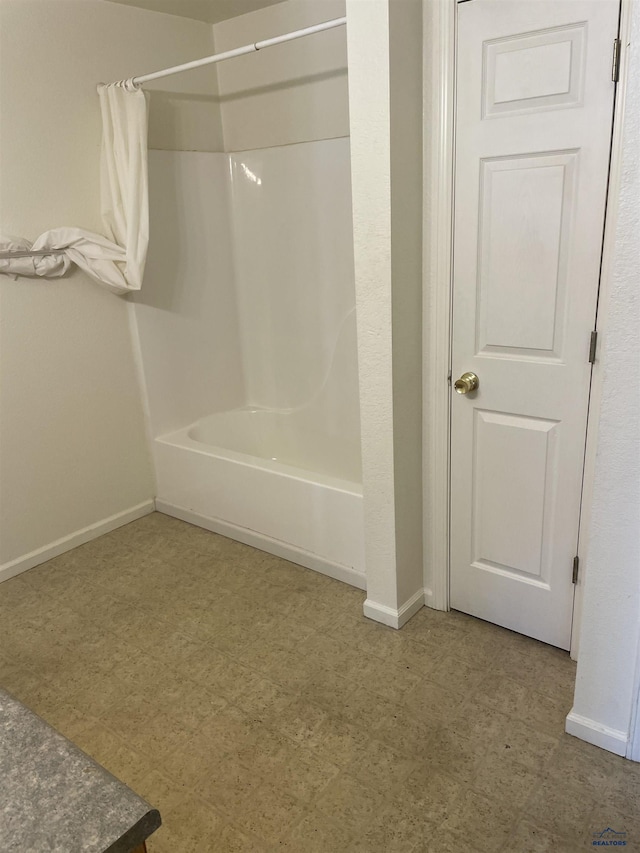 1111 Silver St, Rapid City, SD 57701 - bathroom featuring baseboards, shower / bath combo with shower curtain, and tile patterned floors