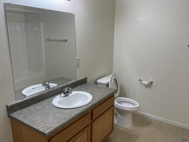 1111 Silver St, Rapid City, SD 57701 - bathroom with a shower, vanity, toilet, baseboards, and tile patterned floors