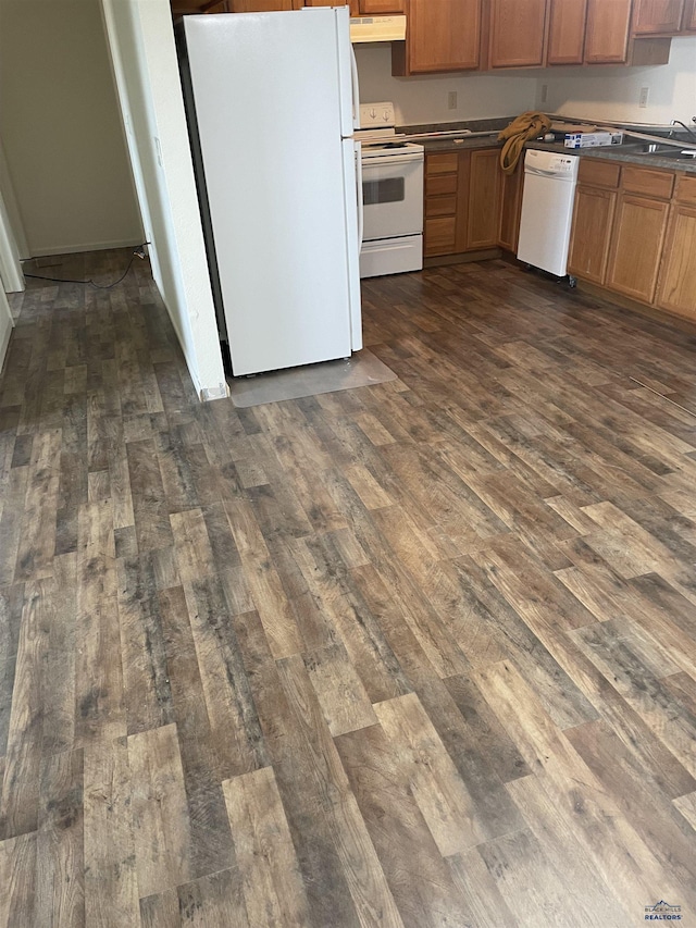 1111 Silver St, Rapid City, SD 57701 - kitchen featuring under cabinet range hood, dark wood-style floors, dark countertops, and white appliances