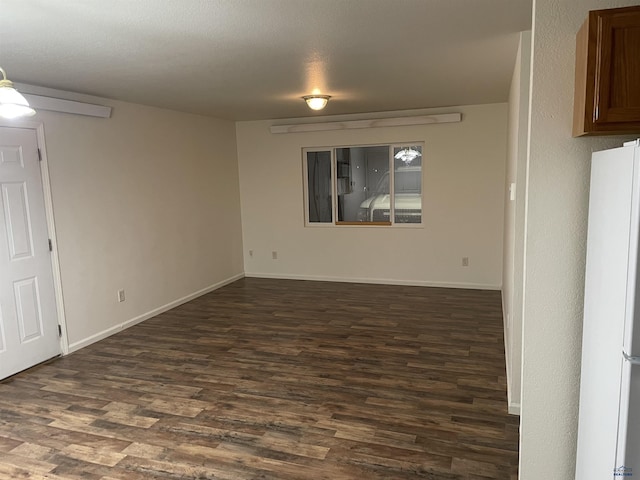 1111 Silver St, Rapid City, SD 57701 - spare room with baseboards and dark wood finished floors
