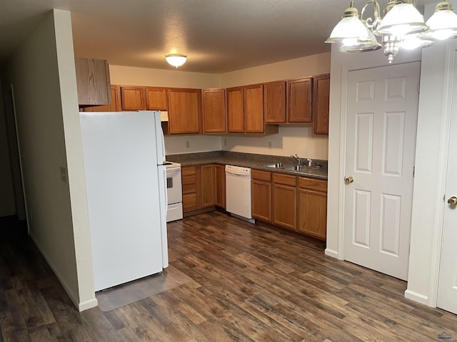 1111 Silver St, Rapid City, SD 57701 - kitchen featuring white appliances, dark countertops, dark wood-type flooring, a sink, and brown cabinetry